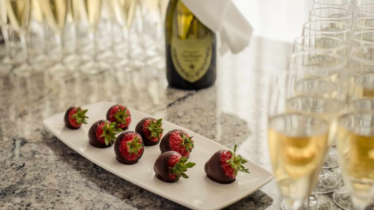 Display of Glasses of Prosecco with chocolate Strawberries for wedding reception