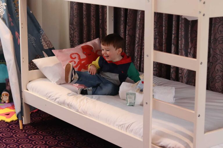 Toddler jumps on the bunk bed