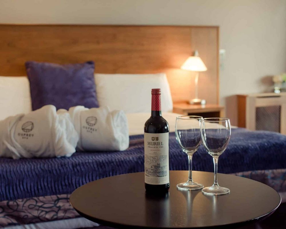 Osprey Hotel Bedroom with wine bottle